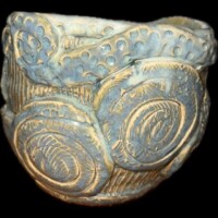 ceramic vessel decorated with tentacles spirals yellow and grey
