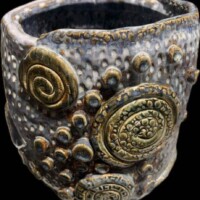 ceramic vessel with spirals and texture colors of earthones and blues