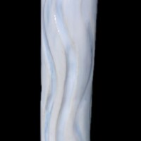 tubular vessel with carved wavy cutaway